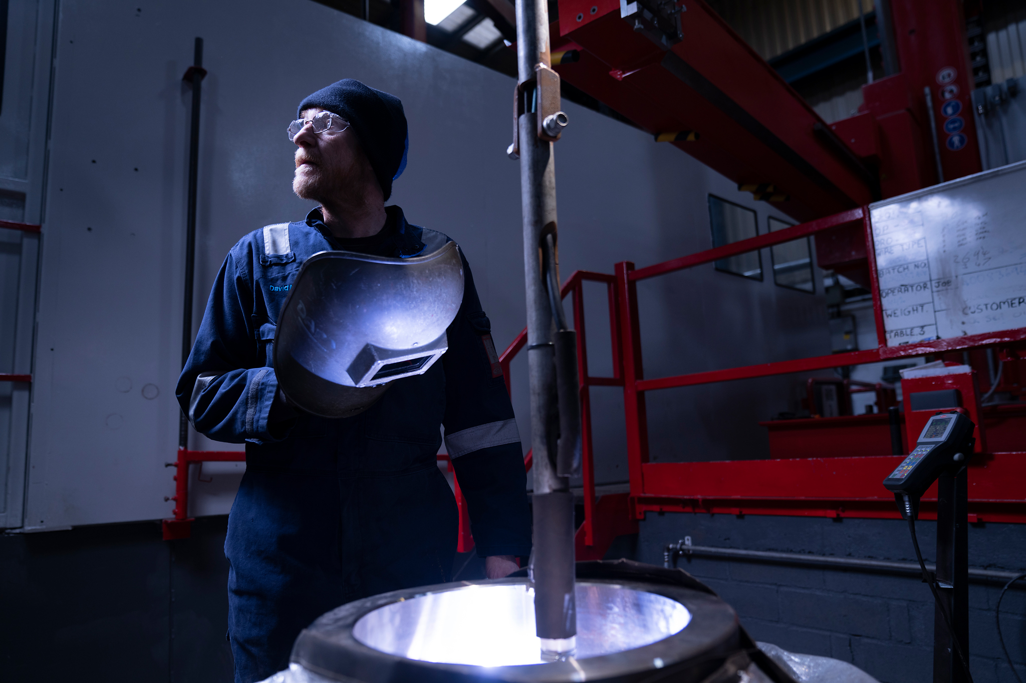 Technician working near molten material in fabrication area