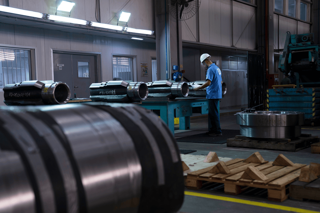 industrial photographer Technician operating large CNC lathe