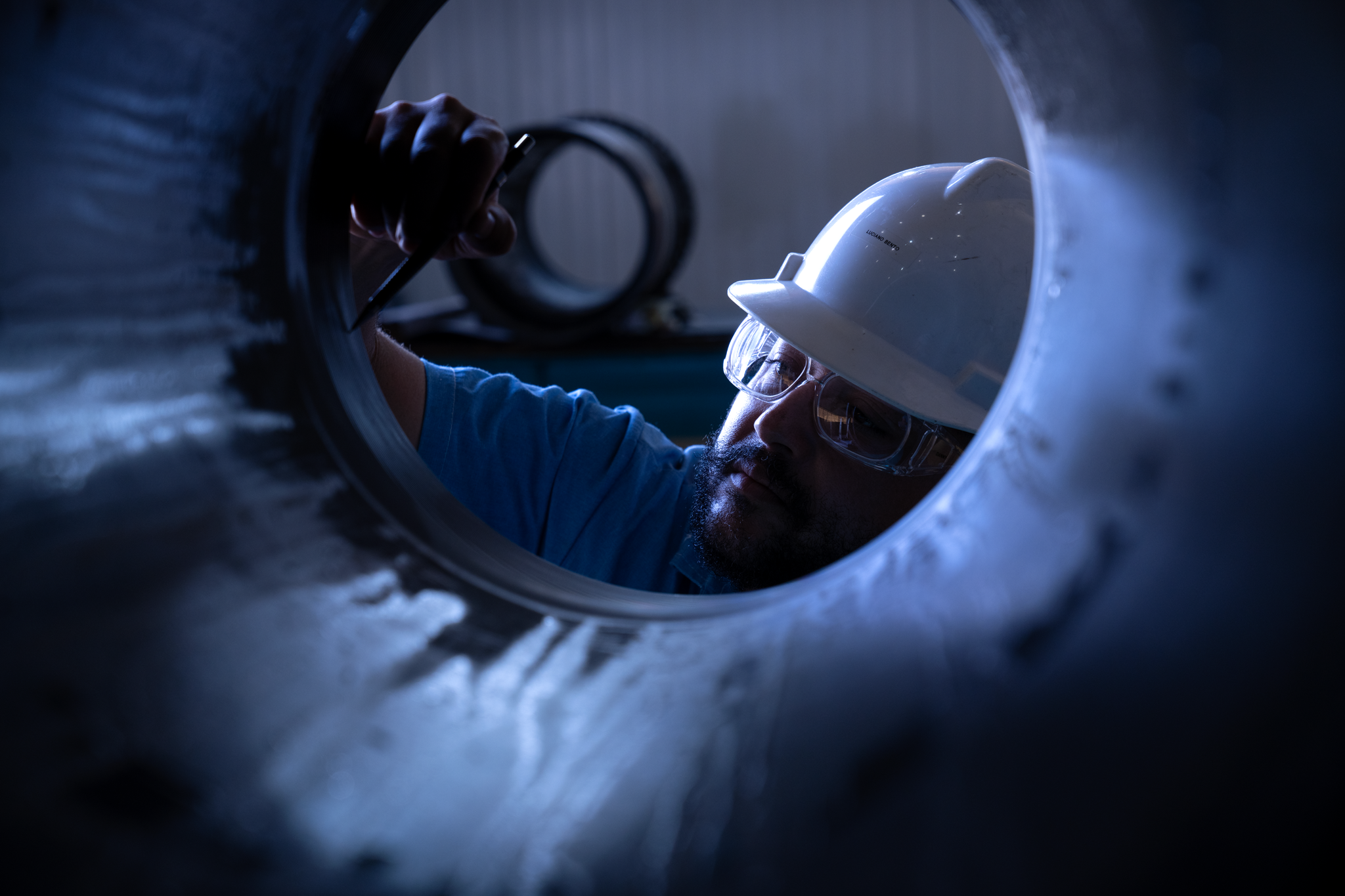 Technician inspecting interior of large component