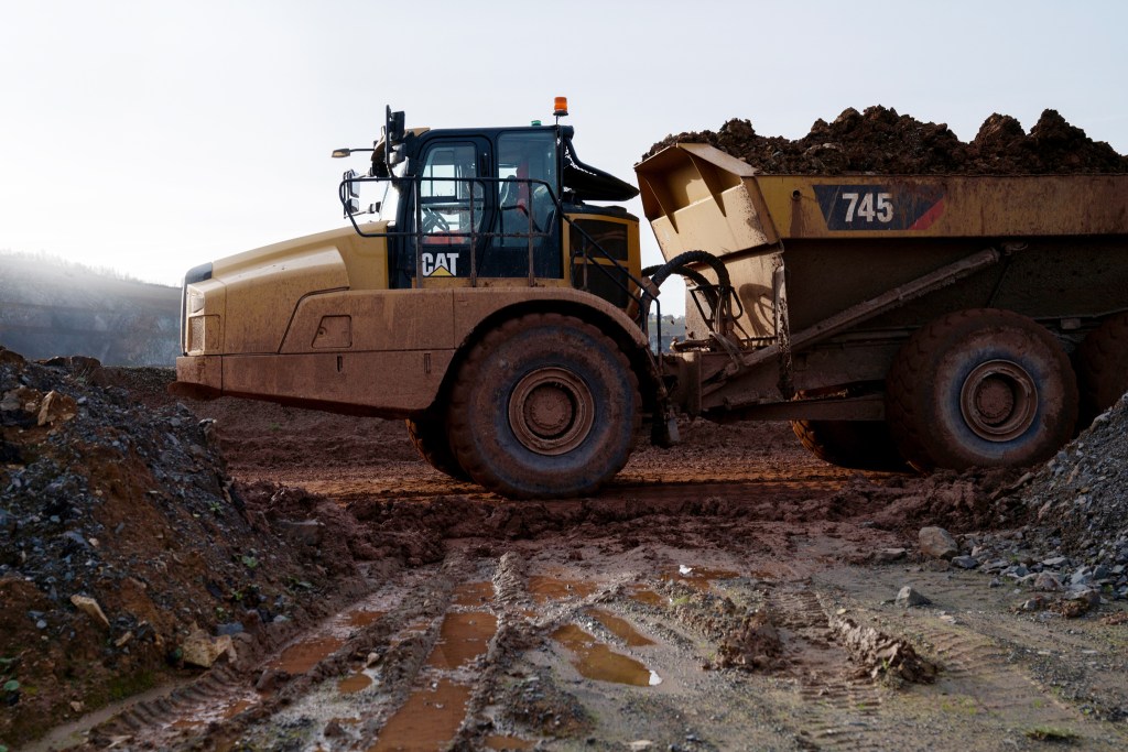 industrial photographer CAT industrial vehicle hauling stone in a quarry
