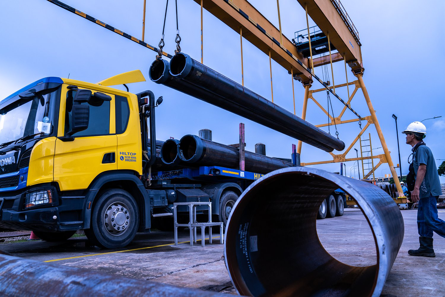 Crane loading large component onto truck